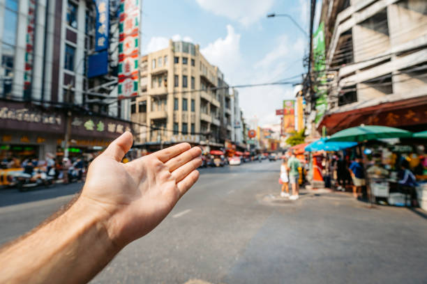 Young man's hand as he is showing Chinatown in Bangkok in Thailand.