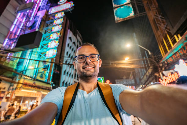 istock Young Man Taking Selfies In Chinatown In Bangkok At Night 2083660492
