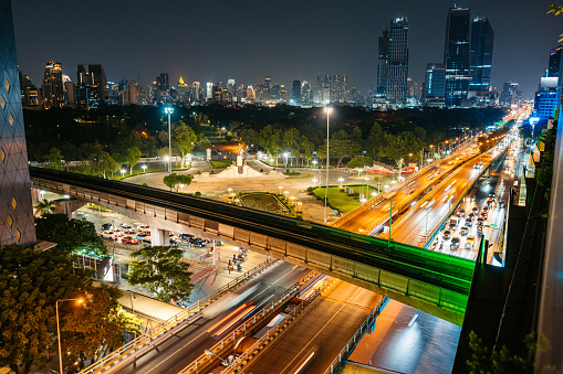 Si Lom district on the Rama IV Road in the Lumpini Park in Bangkok in Thailand at night.