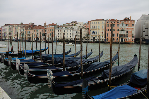 Venice, the capital of the Veneto region, lies on more than 100 small islands within a lagoon in the Adriatic Sea. In this city there are no streets but canals, including the Grand Canal, lined with Renaissance and Gothic palaces. View of the city of Venice on the Grand Canal and gondolas for tourists.