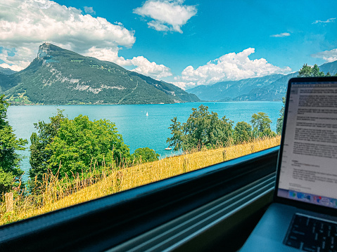 POV Personal Perspective of Telecommuting using a Laptop from a Train near Interlaken Switzerland in Europe