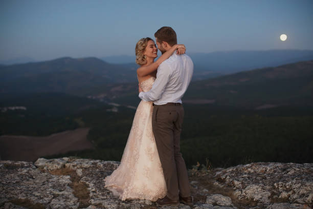 istock Newlyweds hug at night in the mountains 2083712342