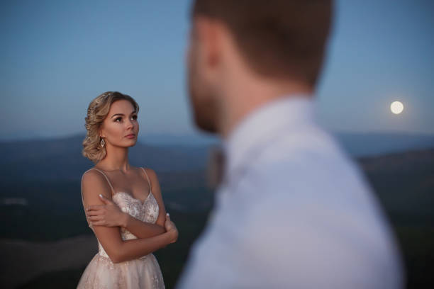 The bride and groom at night in the mountains