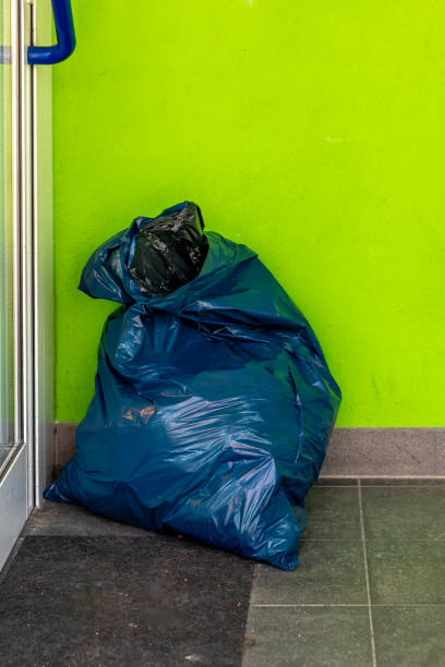 istock a blue garbage bag on a street 2083719606