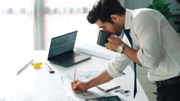 istock Architect engineer using laptop planning house design at office. Alimentation. 2083741294