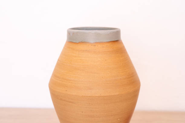 istock Handmade thrown flower vase on wooden counter 2083753967