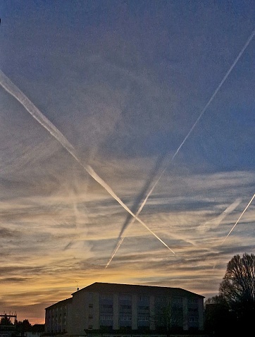 The amazing morning light in English countryside in Hertfordshire UK with contrails from aircraft above, 14th March 2024