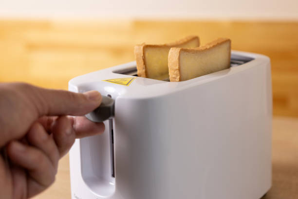 istock To make toast, bread is loaded into an electric 2083772874