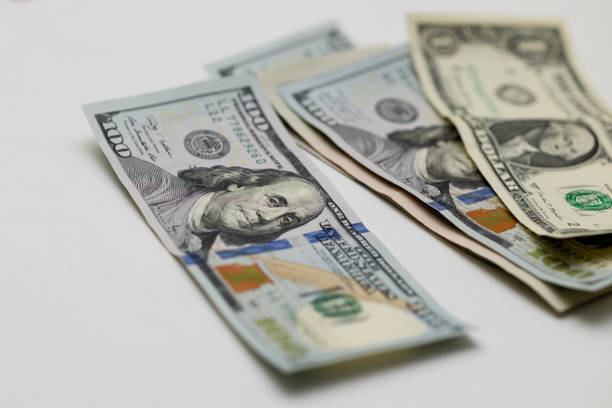 US dollars of different denominations on a light gray background. Close-up