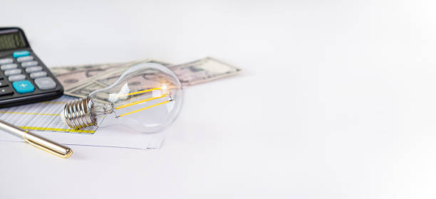 istock light bulb calculator and money on white table space for text, business concept 2083795554
