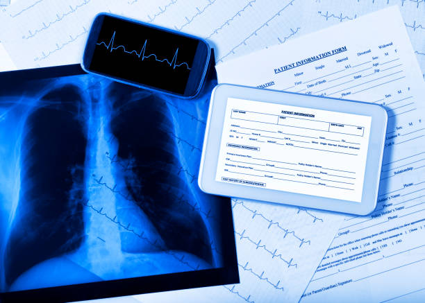 medical exam concept, blue toned. - digital tablet doctor note pad x ray image - fotografias e filmes do acervo