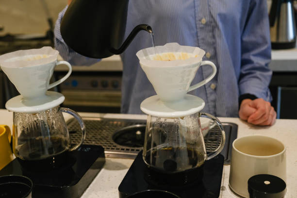 istock Asian Barista Pouring Hot Water Into Coffee Drip Filter 2083805769