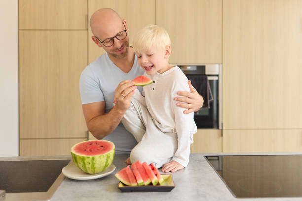 istock A father shares a watermelon with his young son 2083815906