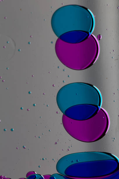 Colored oil bubbles primary colors red, green yellow floating in water