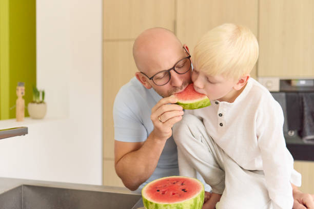 istock A father shares a watermelon with his young son 2083818654