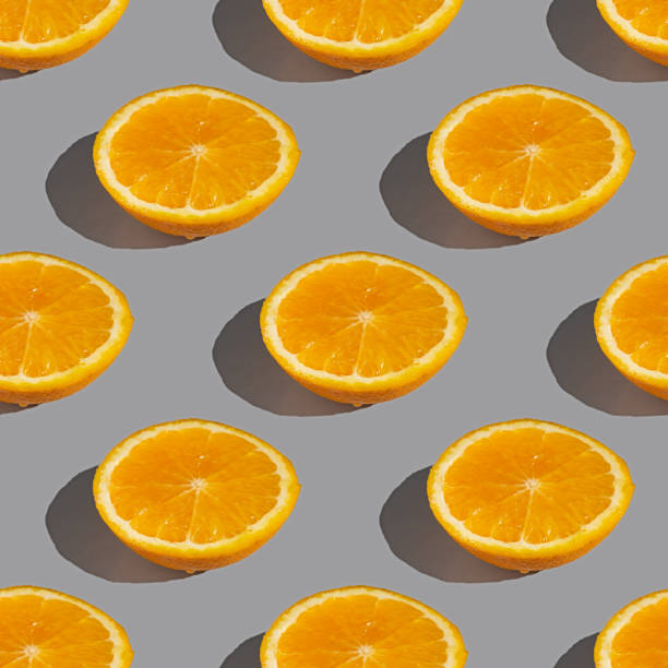 istock Seamless pattern of lemon or orange slices with shadow on a gray background. Flat layout 2083835802
