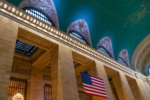 Grand Central station, New York City, USA. The ceiling has gold astrological  or constellation symbols on a green background.