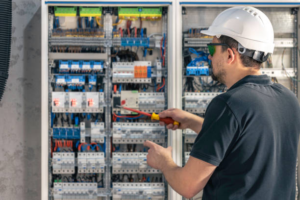 istock A male electrician works in a switchboard using an electrical connection cable. 2083862197