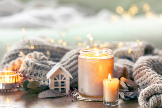 istock Cozy composition with candles and a knitted element on a blurred background. 2083865953