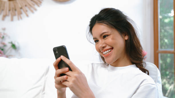 istock Young woman using smartphone browsing for online shopping E commerce by online payment gateway at vivancy home. Modern and convenience online purchasing make secure and convenient purchases. 2083885031