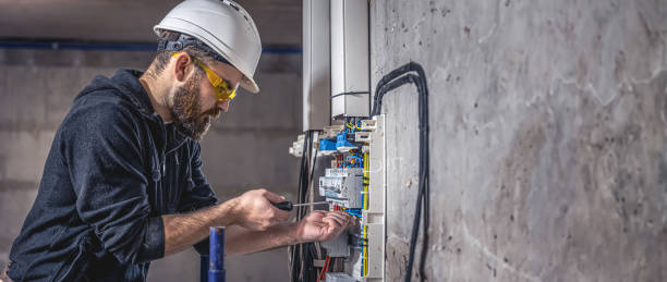 istock A male electrician works in a switchboard with an electrical connecting cable. 2083915962
