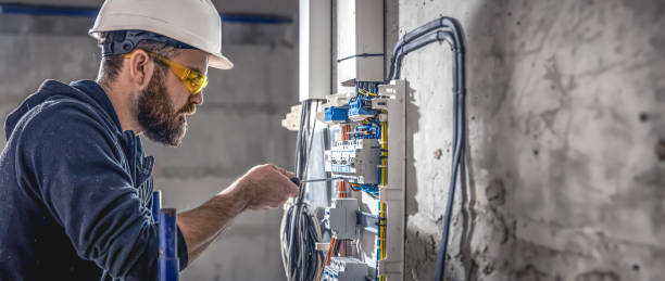 istock A male electrician works in a switchboard with an electrical connecting cable. 2083915963