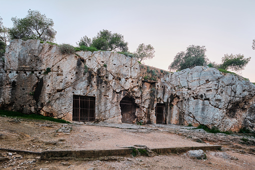 Athens, Greece - March 02, 2024: The prison of Socrates in Athens on Filopappou Hill consists from several caves carved into tough rock