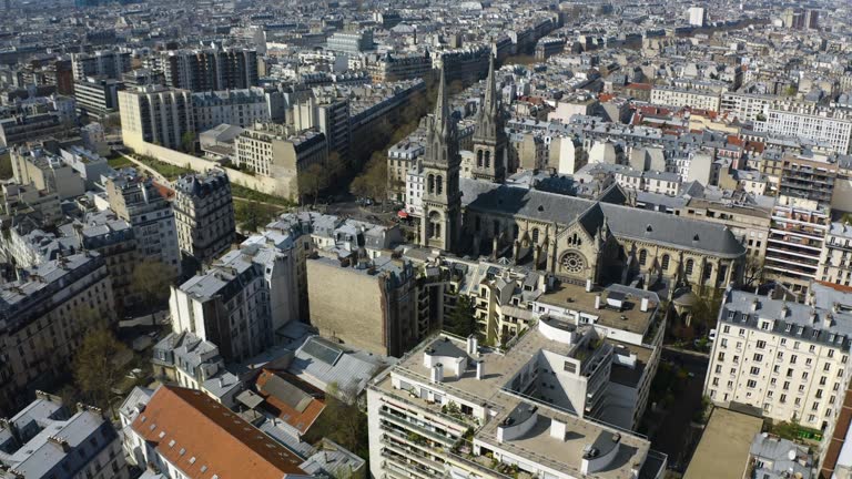 Drone tilting toward the Eglise Saint-Ambroise church, spring in Paris, France