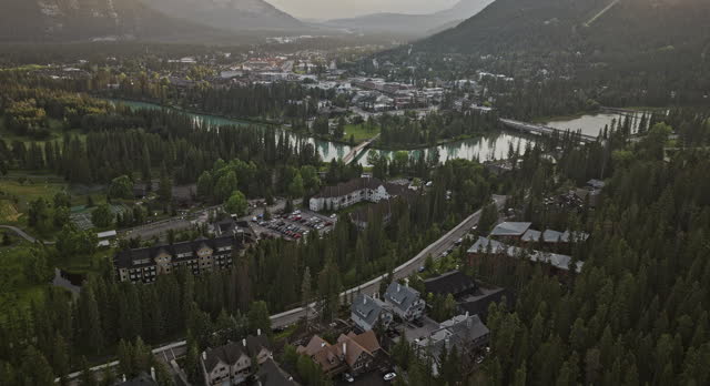 Banff AB Canada Aerial v17 drone flyover residential neighborhood towards the town across Bow river capturing local community surrounded by forested valleys - Shot with Mavic 3 Pro Cine - July 2023