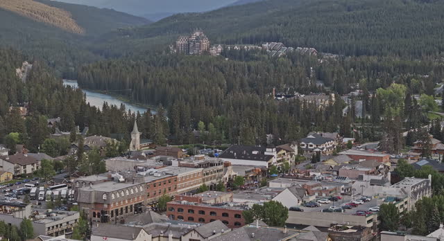 Banff AB Canada Aerial v6 zoomed drone flyover town center capturing townscape with quaint streets lined with shops and restaurants and Bow river views - Shot with Mavic 3 Pro Cine - July 2023