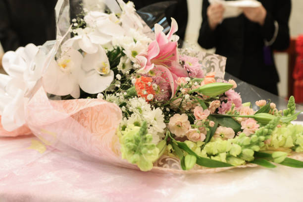 bouquet on the coffin bouquet on the coffin while Funeral ceremony in Japan pink memorial candle with flowers stock pictures, royalty-free photos & images