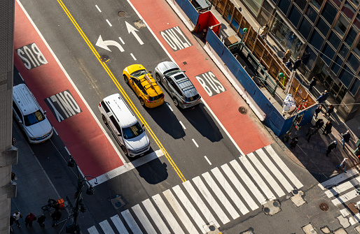 Manhattan, New York, USA - March 2024. Aerial view photography of New York City.  This is on a bright spring day with yellow cabs near a cross roads.