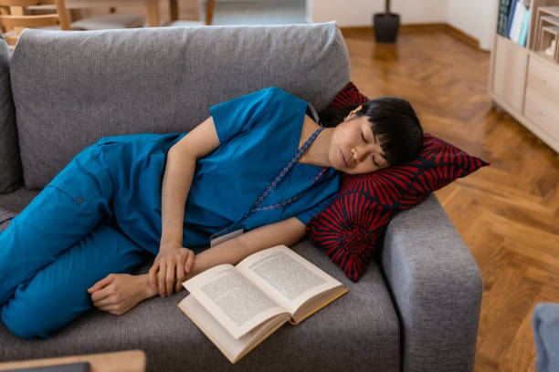 istock Female Doctor in Uniform Sleeping on Comfortable Sofa 2083961061