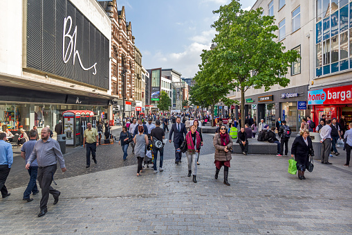 View along a main street in the centre of Liverpool, UK.  Shops can be seen and people can be seen on the pavements.