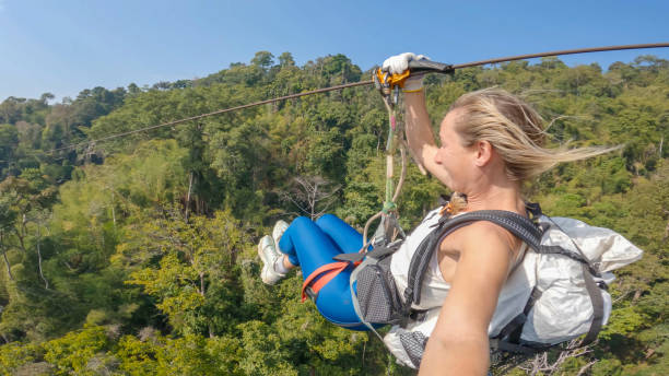 istock Dawn Glide: Woman Zip-Lining Through Laos' Tropical Rainforest 2083991914