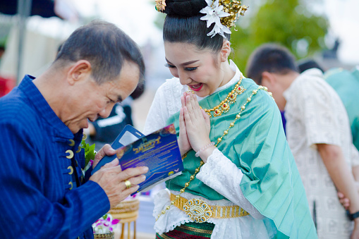 Bangkok,Thailand-May 13,2015 : Unidentified Government officials sowing the grain attend the ceremony -Perform for an auspicious beginning for planting season in the annual Ploughing Ceremony usually takes place in May every year at Sanam Luang near the Grand Palace in Bangkok. The ceremony has been performed since ancient times and designed to give an auspicious beginning to the new planting season on May 13,2015 in Bangkok , Thailand.