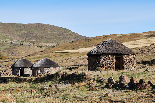 Semonkong, Lesotho - April 22nd 2023 - group of traditional round huts made of stones near Semonkong