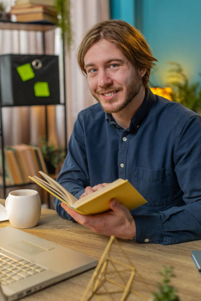 istock Business man reading book turning pages smiling enjoying literature taking a rest relaxing at office 2084040729