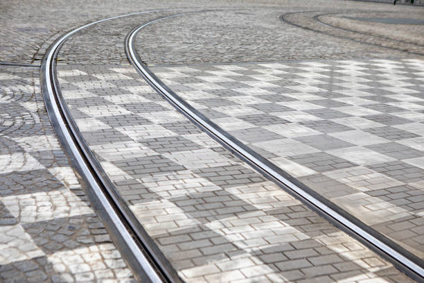 Tram tracks across a chequered road surface in the city of Brussels, Belgium
