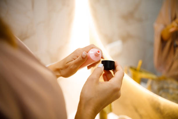 istock Morning Glow: Woman's Bathroom Ritual with Face Cream 2084089239