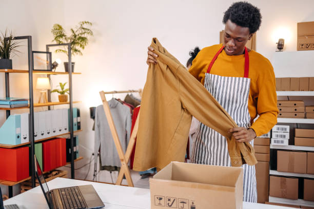 istock Young people picking clothes to fulfill customer order 2084105188