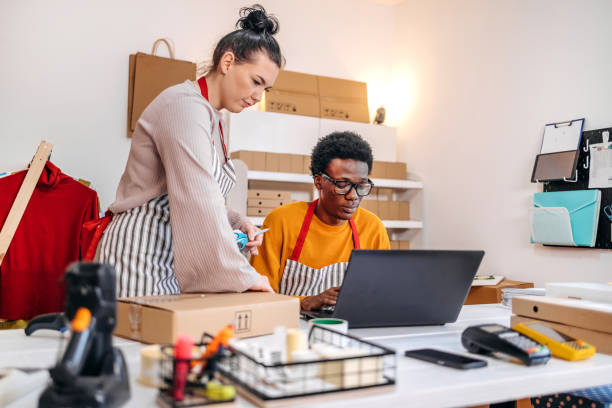 istock Young people working in packing and delivery service and using laptop to complete job 2084106241