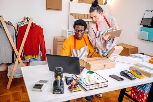 istock Young people working in packing and delivery service and using laptop to complete job 2084107444