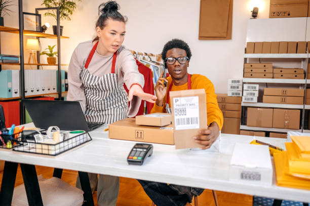 istock Young people working in packing and delivery service and using laptop to complete job 2084108352