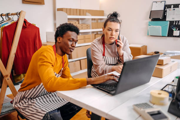 istock Young people working in packing and delivery service and using laptop to complete job 2084109377