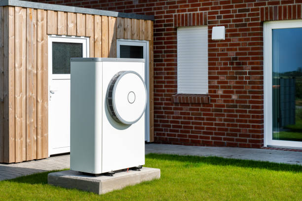 istock Heat pump, sustainable heating solution for modern homes. Environmentally Friendly Heat Pump Technology in Front of a brick house. 2084114061