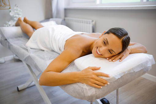 Gentle Relaxation: Close-Up of Serene Woman on Massage Table