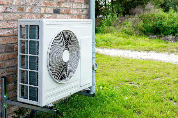 istock Heat pump, sustainable heating solution for modern homes. Environmentally Friendly Heat Pump Technology in Front of a brick house. 2084114078