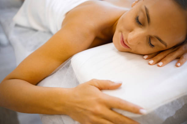 istock Restorative Repose: Youthful Woman Finding Peace on Massage Bed 2084114086