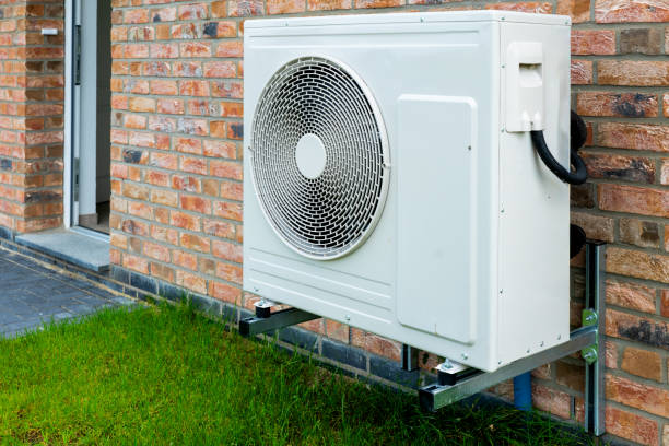 istock Heat pump, sustainable heating solution for modern homes. Environmentally Friendly Heat Pump Technology in Front of a brick house. 2084115133